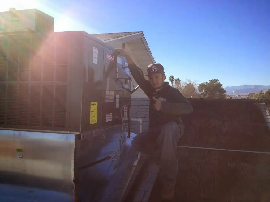 HVAC technician performing HVAC Inspection on a rooftop unit in Perryton